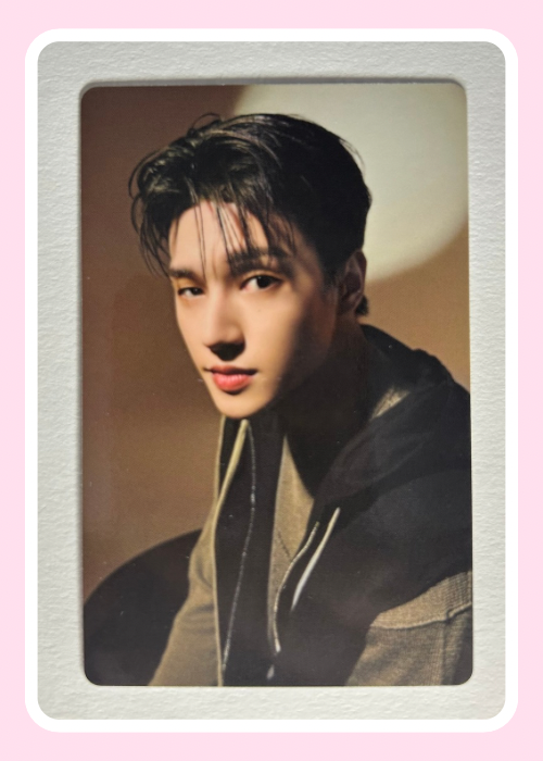 Wooyoung from Ateez wearing a dark jacket