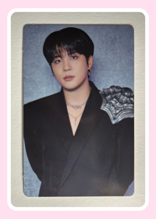 Jongho Ateez wearing a black outfit with decorative elements.