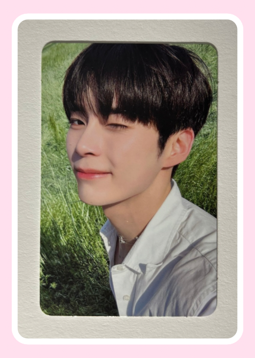 Sung Hanbin Zerobaseone with dark hair standing outdoors 